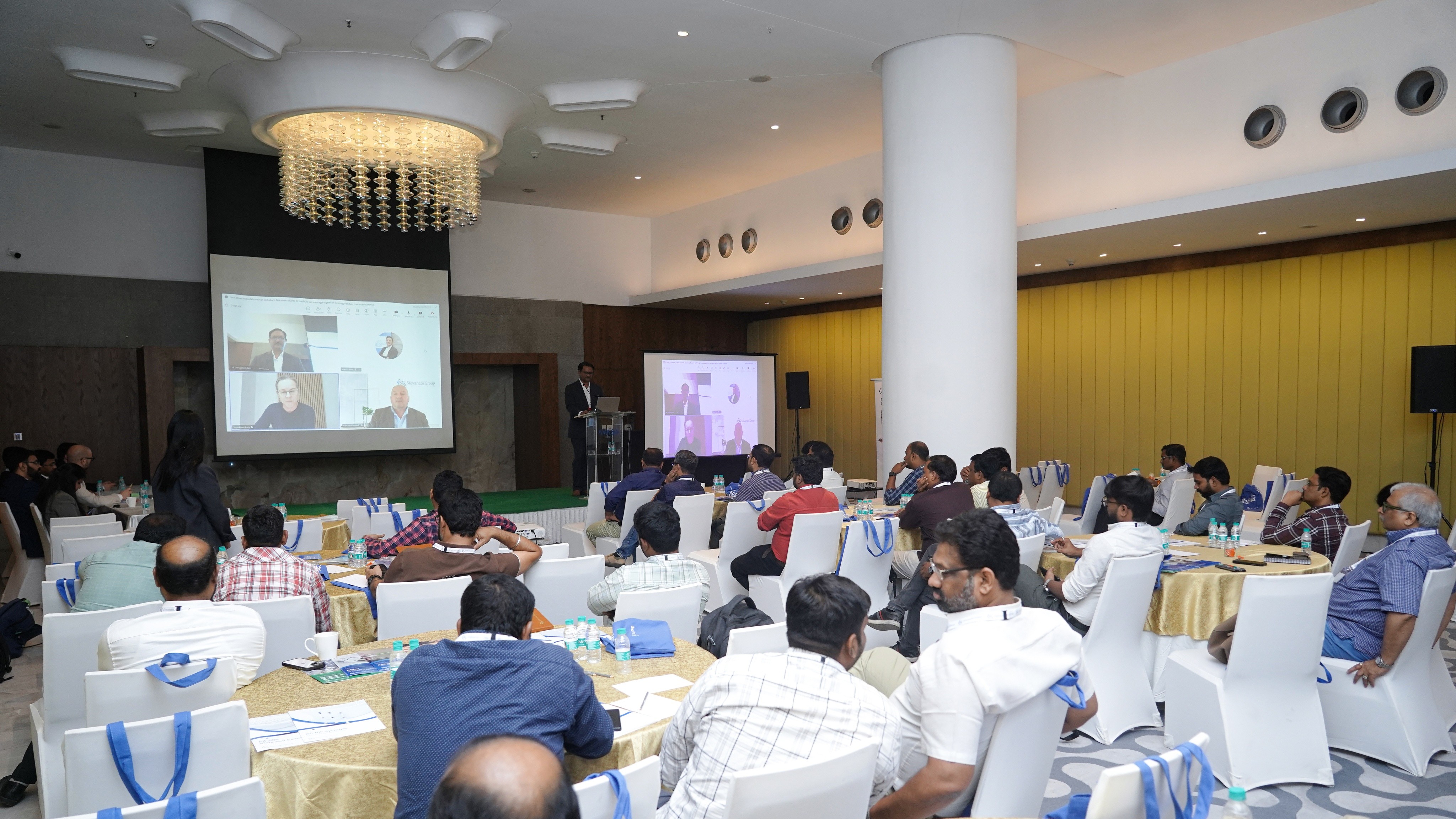 Audience at conference and speakers from remote